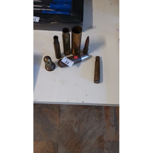 23 - A collection of vintage brass shell casings, various sizes and designs.