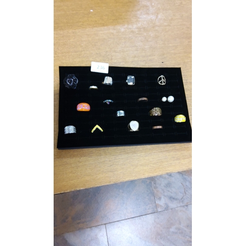 236 - Assorted costume rings,feature various designs, materials, and finishes.