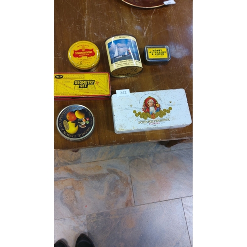 242 - A collection of vintage tins, including tobacco, confectionery, and a geometry set. Includes a Schim... 