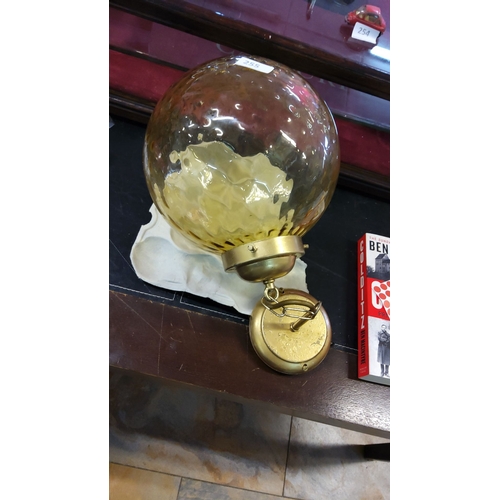 255 - Vintage brass and amber glass ceiling light with textured globe shade.