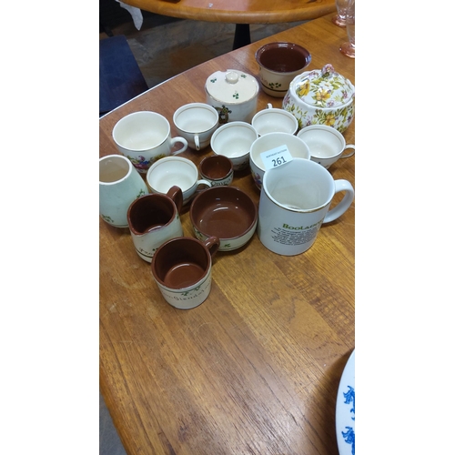 261 - Assorted ceramic and earthenware items, including cups, bowls, mugs, and lidded sugar pots with flor... 