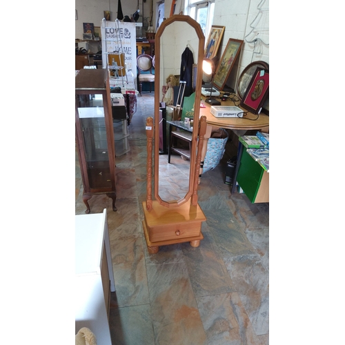 283 - Vintage pine cheval mirror with tilting frame and lower storage drawer, featuring turned supports an... 