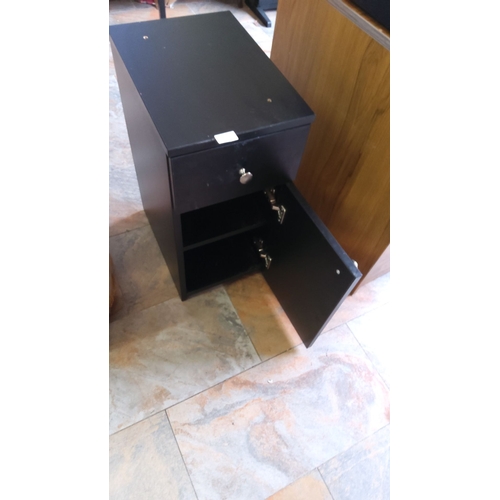 286 - Black wooden storage cabinet with a single drawer and lower storage compartment. Features metal hand... 