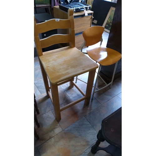 289 - Pair of vintage wooden and metal bar stools. One features a classic ladder-back design, the other a ... 