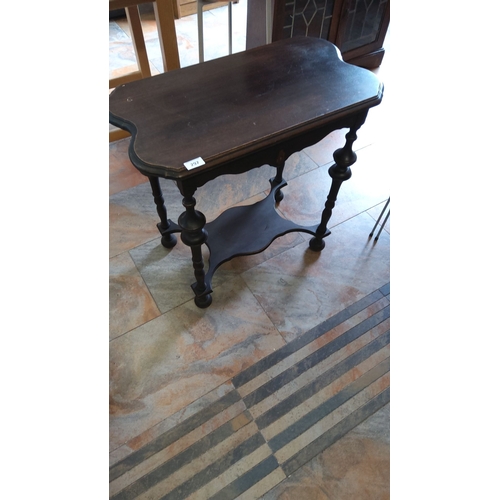 297 - Edwardian-style dark wood side table with a shaped top, turned legs, and lower shelf.