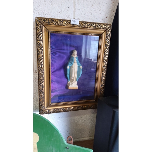 314 - Framed religious shadow box features a Madonna figurine against a deep purple fabric background and ... 