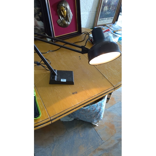 324 - Black adjustable desk lamp with a bakelite base, articulating arm, and metal shade.