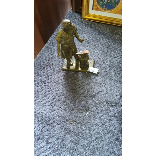 331 - Cast brass figurine of a blacksmith at work, mounted on a rectangular base.