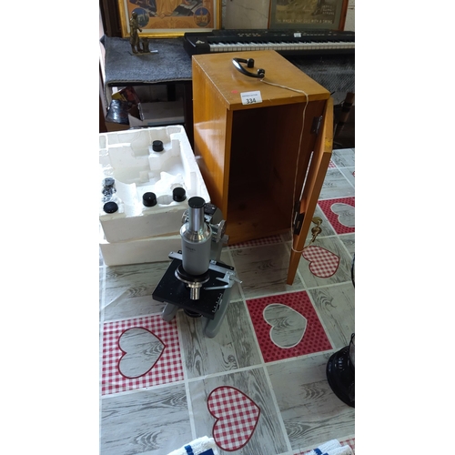 334 - Vintage monocular microscope with multiple objective lenses, housed in a wooden case. Includes acces... 