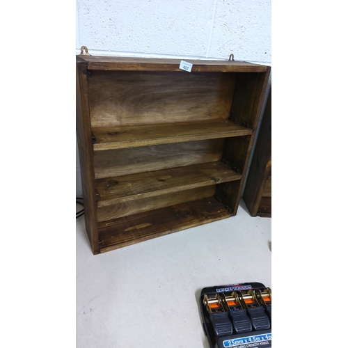 402 - Wooden wall-mounted shelf with three tiers and a stained finish. Includes hanging hardware.