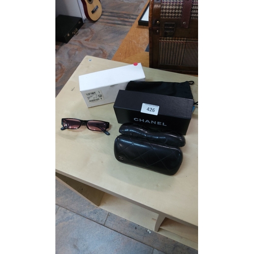 426 - Chanel genuine designer sunglasses have black frames and tinted lenses, accompanied by two quilted l... 