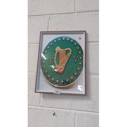 438 - Framed print of an Irish Volunteer uniform button encased in a simple wooden frame