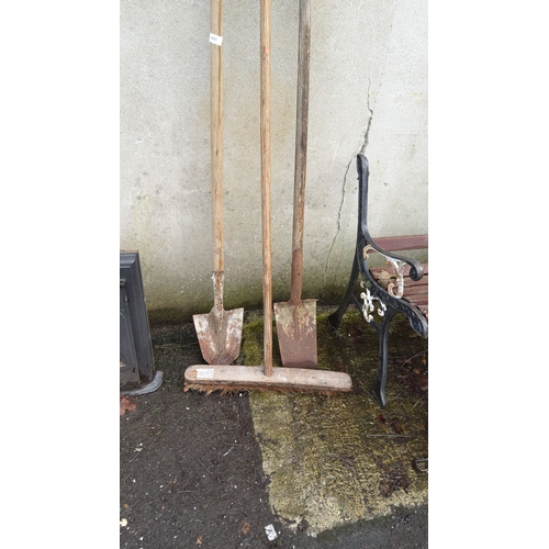 440 - Three vintage gardening tools, including two spades with wooden handles and a push broom.