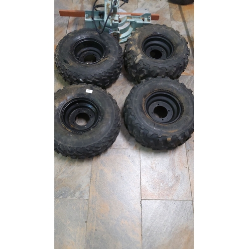 449 - Set of four rugged off-road quad tires with black steel rims.