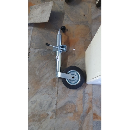 456 - Heavy-duty trailer jockey wheel with sturdy metal frame and rubber tire. Features adjustable height ... 