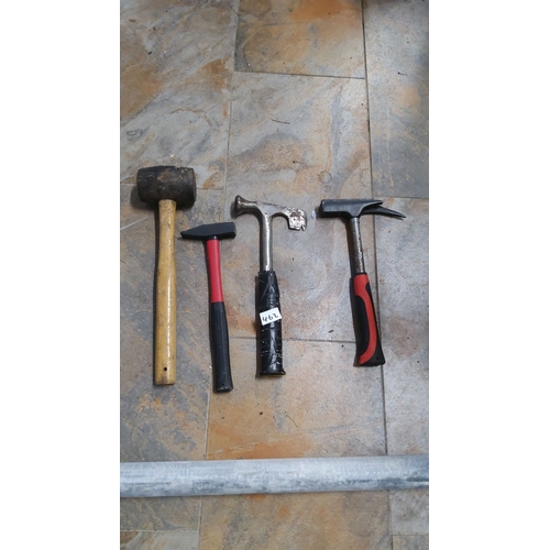 462 - Lot of four assorted hammers, including a rubber mallet, claw hammer, and specialized masonry tools.