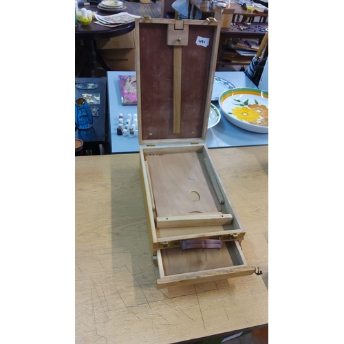 491 - Vintage wooden painter's box easel with storage compartments and brass fittings. Includes a leather ... 