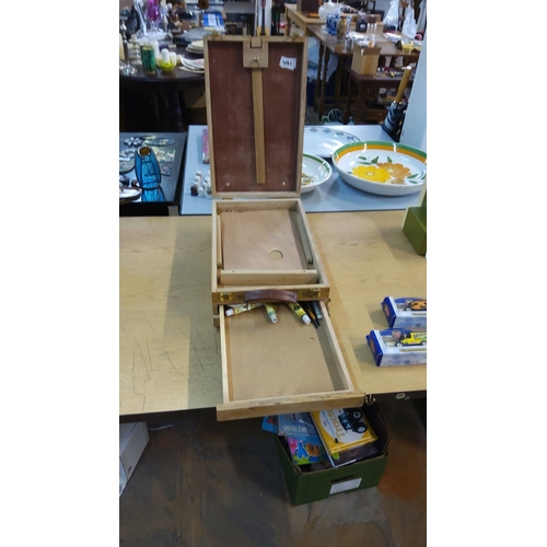 491 - Vintage wooden painter's box easel with storage compartments and brass fittings. Includes a leather ... 