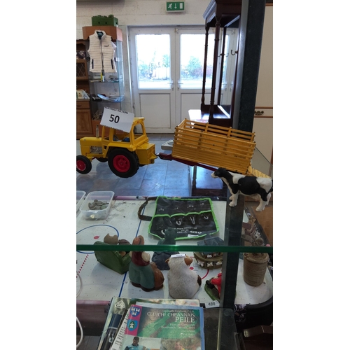 50 - Vintage diecast farm tractor with detachable yellow livestock trailer, accompanied by a plastic Hols... 