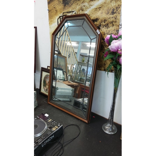 74 - Octagonal wall mirror with beveled glass and wooden frame featuring decorative trim.