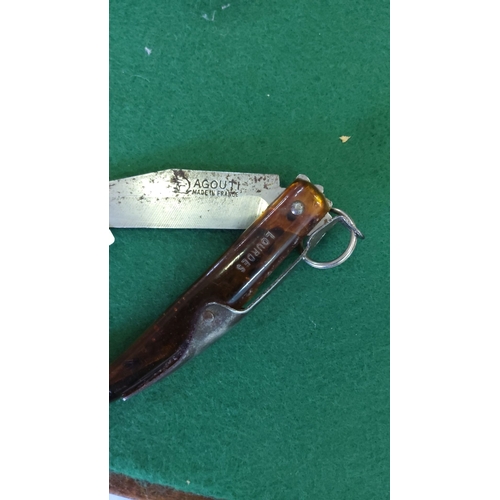 113 - Vintage French folding knife by Agouti, featuring a distinctive horn-shaped amber-toned handle marke... 