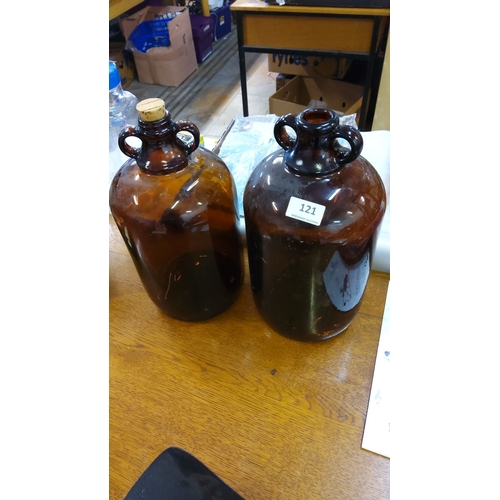 121 - Pair of vintage glass demijohns with twin-handled design, one with original cork stopper.