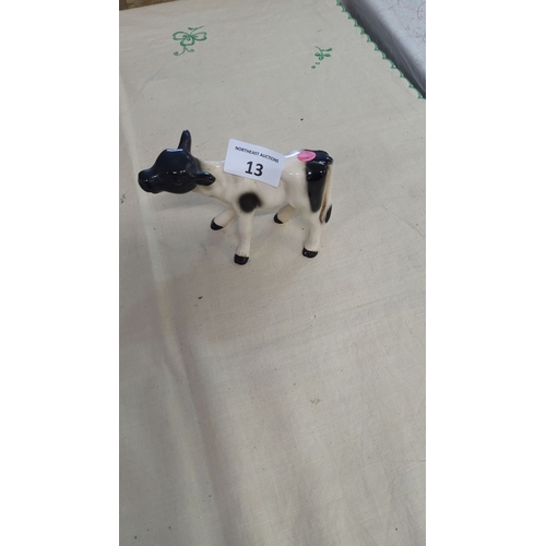 13 - Hand-painted ceramic cow figurine with black and white detailing, featuring glossy glaze.