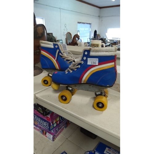 136 - Vintage 1970s high-top roller skates with vibrant blue, red, and yellow accents. Metal plate with ye... 