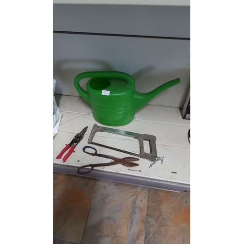 147 - Mixed lot including a green plastic watering can, metal tin snips, and a hacksaw.