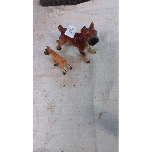 176 - Pair of vintage ceramic Boxer dog figurines with hand-painted details and a glossy finish.