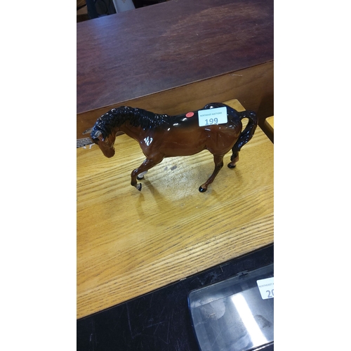 199 - Glossy ceramic Beswick horse figurine, detailed in a rich bay color with black mane and tail.