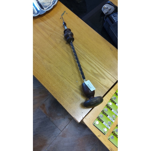 202 - Antique hand brace drill with twisted metal shaft and turned wooden handles.