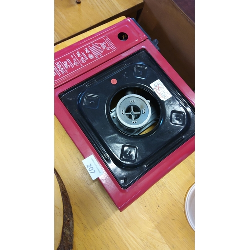 207 - Portable single-burner gas stove with red metal casing and black enamel surface.(w)