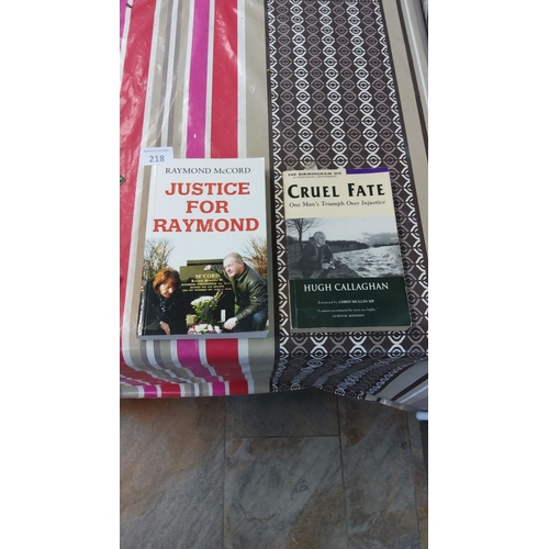 218 - Two paperback books—*Justice for Raymond* by Raymond McCord and *Cruel Fate* by Hugh Callaghan.