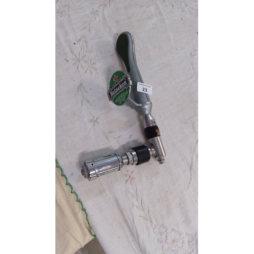 23 - Heineken beer tap handle features a green and silver ergonomic handle with branded logo.