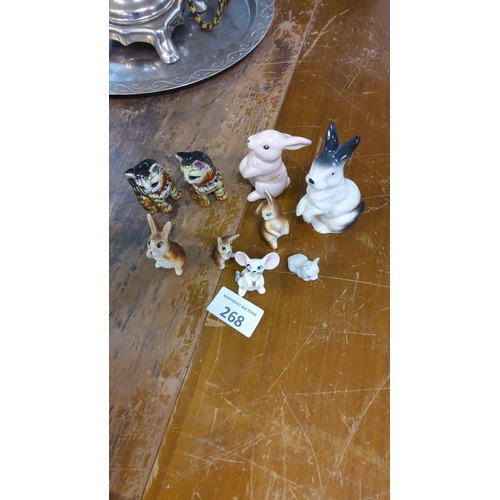 268 - Vintage porcelain animal figurines, including rabbits, cats, and a mouse. Fine detailing and hand-pa... 