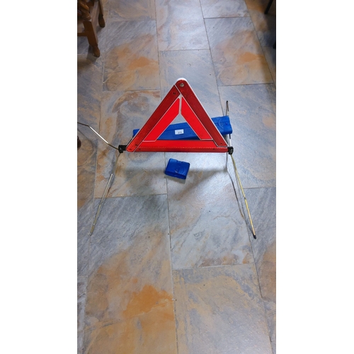 271 - Reflective roadside warning triangle with collapsible metal stand and plastic storage case. Folds fo... 