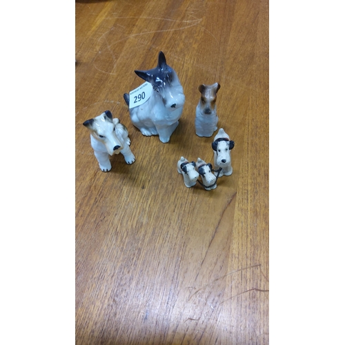 290 - Five vintage porcelain dog figurines, including a chained trio, hand-painted with fine detailing.