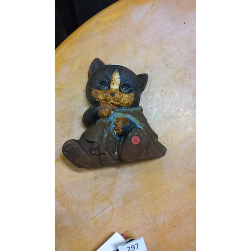 296 - Cast iron doorstop featuring a seated kitten holding a cloth.