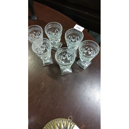 299 - Set of six vintage cut glass goblets with intricate geometric patterns and square bases.