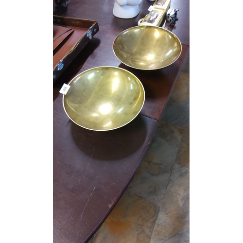 303 - Pair of vintage brass bowls with a polished finish.