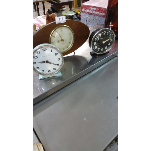 312 - Trio of vintage Westclox clocks, including a mid-century wood-mounted model with metal and plastic c... 