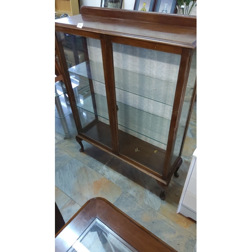 324 - Vintage 1960s wooden display cabinet with glass doors and shelves, featuring cabriole legs and a rai... 