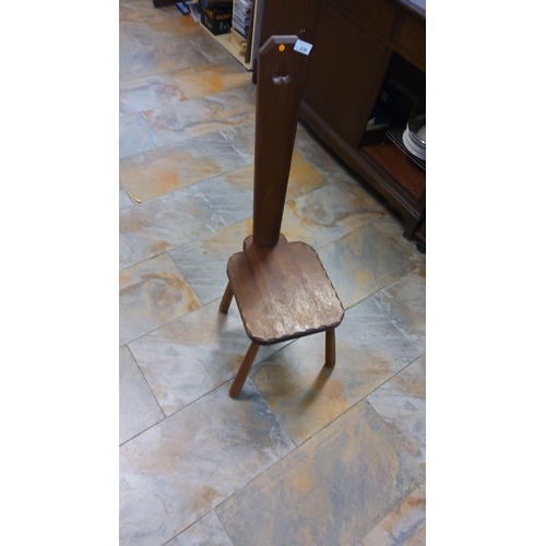 336 - Rustic wooden stool with carved backrest and scalloped seat edges.