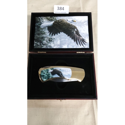 384 - Folding knife with gold-tone accents, featuring a striking eagle design. Presented in a decorative d... 