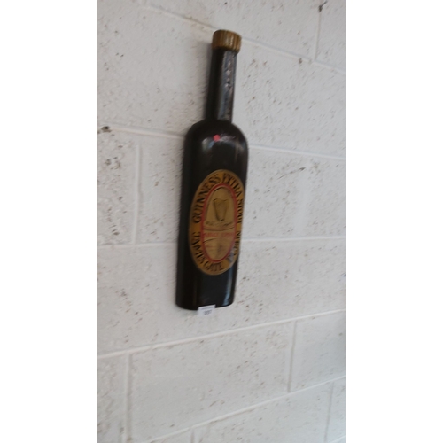 397 - Vintage Guinness Extra Stout wall plaque,carved and shaped like a bottle. Hand-painted, from the mid... 