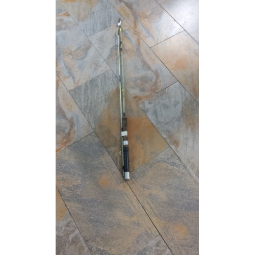 401 - Vintage fishing rod with cork and metal reel seat, featuring multiple line guides.