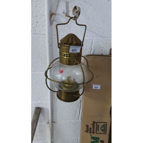 405 - Brass ships light with protective wire cage and glass globe. Classic maritime design.