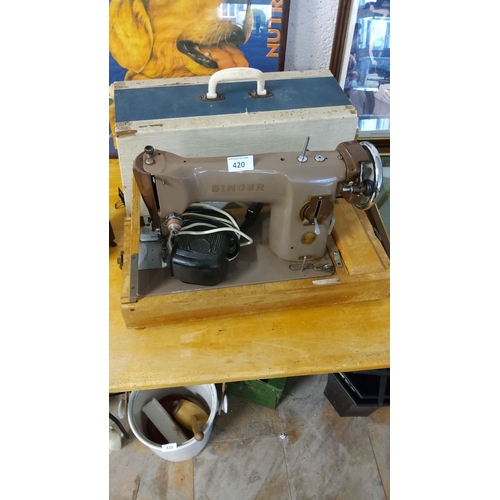 420 - Vintage Singer sewing machine with original case and foot pedal. Features a sturdy mid-century desig... 