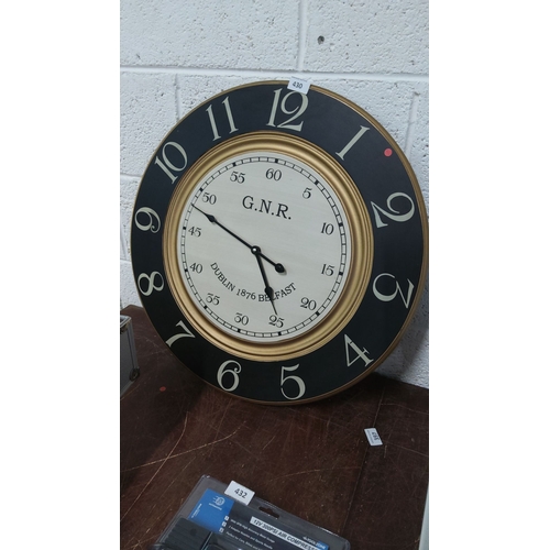 430 - Large G.N.R. wall clock features a classic railway-style design with gold, black, and cream detailin... 